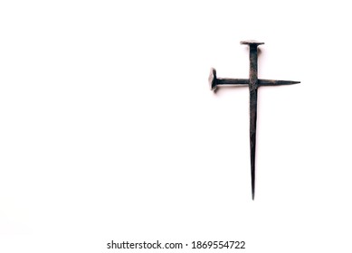Cross made with rusty nails and drops of blood on white background. Copy space. Good Friday, Easter day. Christian backdrop. Biblical faith, gospel, salvation concept. Crucifixion of Jesus Christ.
