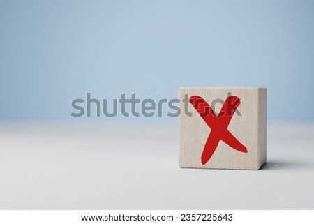 Cross mark x on wooden cube. Rejection sign in wooden cube stack. Concept of negative decision making or choice of vote, againt, resist, contravene law, regulatory, non-compliance concept.