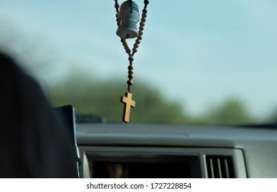 Cross Necklace In The Car Background