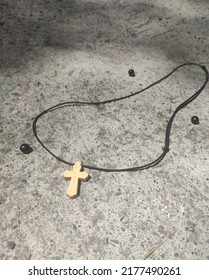 Cross on a black thread