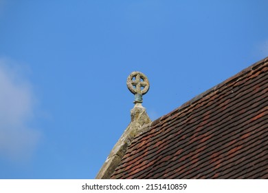 Cross On The Ridge Line Of A Church Roof