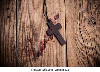 Cross On Wooden Background With Stains Of Blood