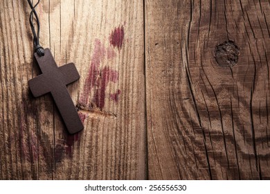 Cross On Wooden Background With Stains Of Blood