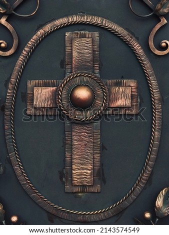 The cross on the wrought iron door