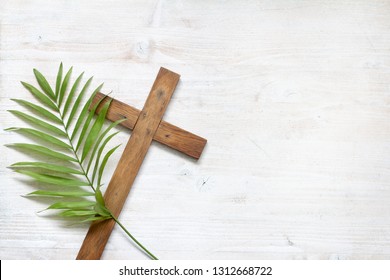Cross and palm on wooden white background easter sign symbol concept