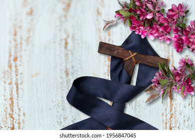 Cross With Purple Sash And Flowers On White Wood