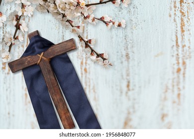 Cross With Purple Sash And Flowers On White Wood