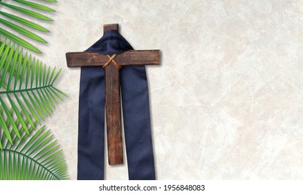 Cross With Purple Sash And Flowers On White Desk