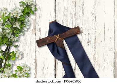 Cross With Purple Sash And Flowers On White Wood