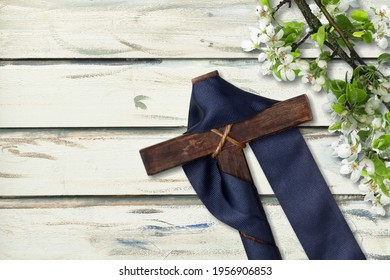 Cross With Purple Sash And Flowers On White Wood