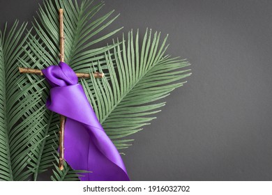cross with purple sash and palms on black background - Shutterstock ID 1916032702