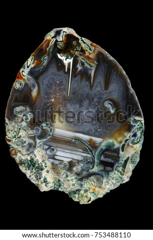 A cross section of the agate stone. Stalactite-horizontal agate with membranes. Multicolored silica rings colored with metal oxides are visible. Origin: Rudno near Krakow, Poland.