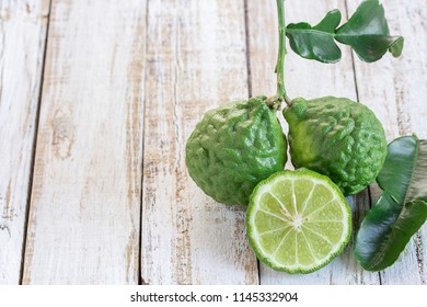 Cross Section Bergamot Or Bergamot Slice.Close Up Bergamot On Wooden Table Background. With Some Juice,popular Ingredient For Thai Cuisine, Also For Hair Shampoo Or Conditioner Treatment. Kaffir Lime