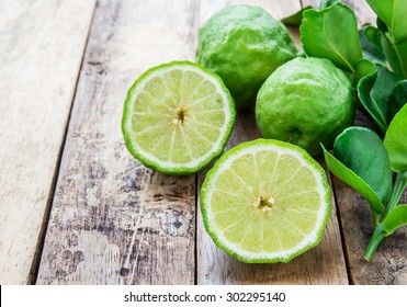Cross section bergamot or bergamot slice.Close up bergamot on wooden table background. with some juice,popular ingredient for Thai cuisine, also for hair shampoo or conditioner treatment. Kaffir lime