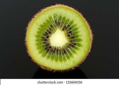 Cross Section Of Kiwi Fruit Against A Black Background