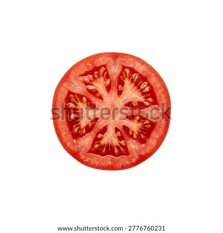 A cross section slice of a ripe red tomato showing seeds and pulp.