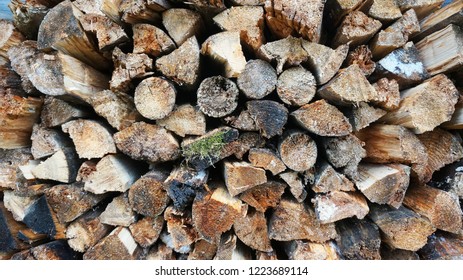        Cross section of the timber, firewood stack for the background. A lot of cutted logs. Stack of sawn logs. Natural wooden decor background. Pile of chopped fire wood prepared for winter.  