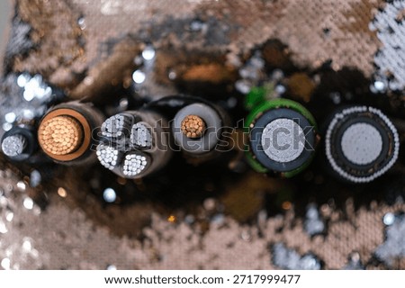Cross section of various electrical cables showing copper and aluminum wires. Power and data transmission technology for industry and infrastructure.