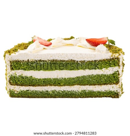 Cross section of vibrant spinach layer cake with creamy frosting and fresh strawberry decoration isolated on white background