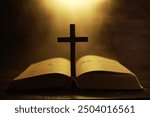 Cross Silhouette on Open Bible with Warm Golden Light in Background - Spiritual Symbolism and Religious Faith