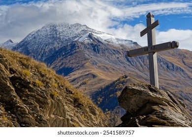 A cross and snowy mountain peaks - Powered by Shutterstock