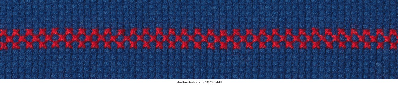 Cross Stitched Red Border On Blue Aida Fabric.