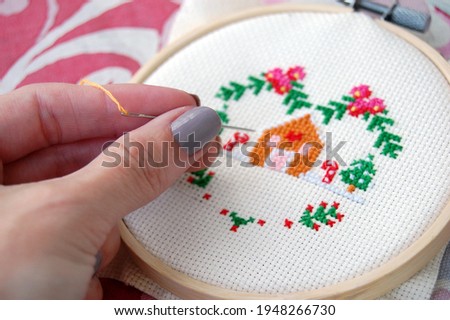 Cross stitching hobby with needle and thread