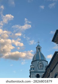 Belltower’s cross touching the sky.