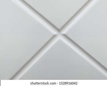 Cross of two diagonal lines on a gray background.  Front view.