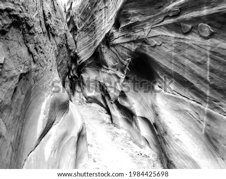 Cross-bedding on the steep cliffs of the Dry Fork slot canyon in in the Grand Staircase-Escalante National Monument, Utah, USA in black and white