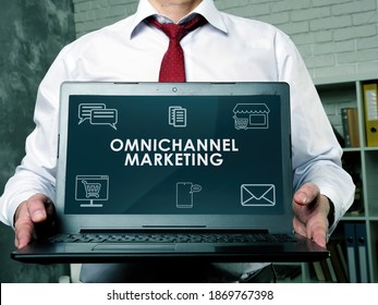 Cross-Channel Or Omnichannel Marketing. The Manager Demonstrates A Laptop With A Report.