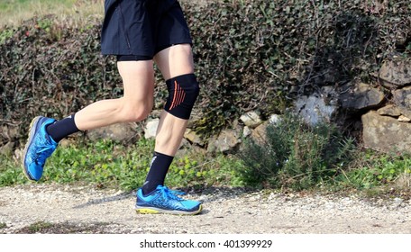 Cross-country Runner During The Race With His Knee Wrapped By A Knee Brace