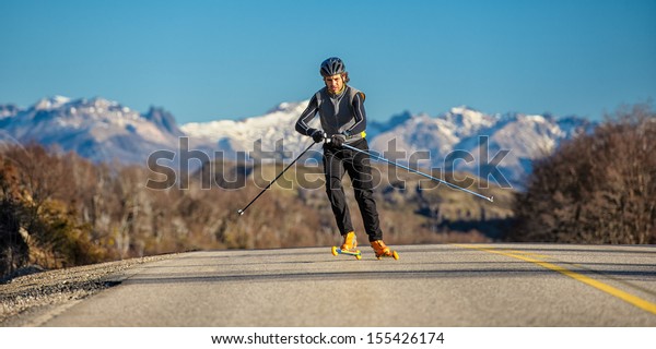 cross-country skiing with roller ski and\
mountain\
background