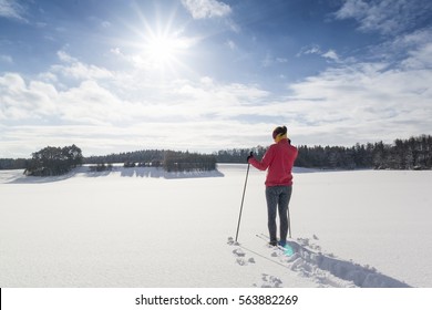 Cross-country skiing woman doing classic nordic cross country skiing in winter