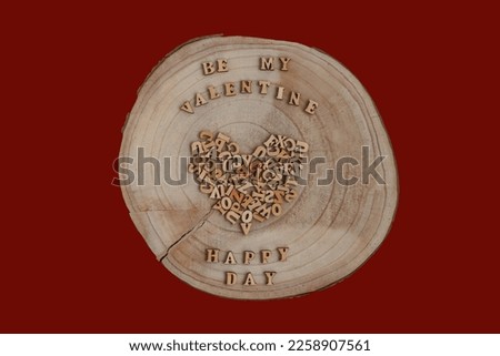 Crossection of an oak tree trunk with letters on red background isolated