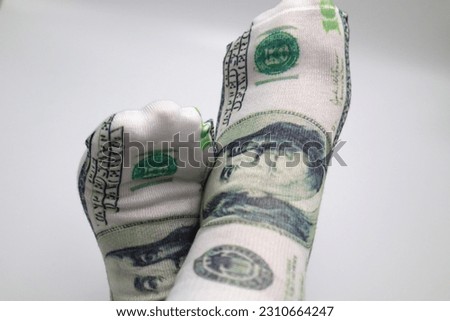 Crossed feet with one dollar bill socks growing Roth IRA 401k dividends stocks fund passive income portfolio investments cashing in and reaching financial economy and wealth success