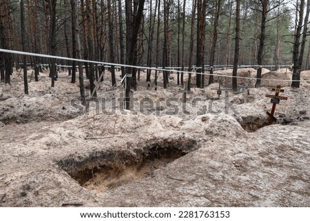Crosses are seen at a forest grave site after an exhumation in the town of Izium, recently liberated by Ukrainian forces, in the Kharkiv region, Ukraine.