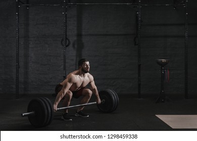 Crossfit Athlete Doing Deadlift Exercise. Muscular Man Practicing Powerlifting At Workout Gym.