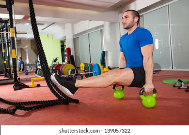 Crossfit Fitness Man L-sits Kettlebells L Sits Exercise At Gym Workout