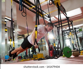 Crossfit fitness TRX push ups man workout at gym - Powered by Shutterstock