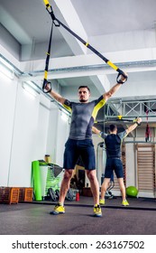 Crossfit Instructor At The Gym Doing TRX Excersise