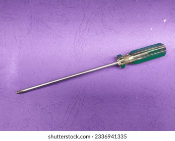 Crosshead screwdriver isolated purple background