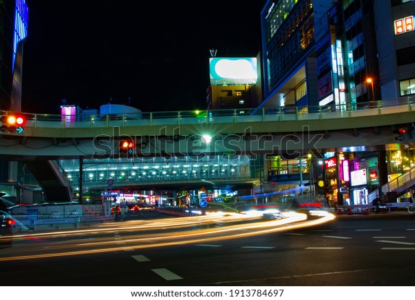 A crossing at the neon town in Shibuya at\
night wide shot. Shibuya district Shibuya Tokyo Japan - 02.05.2021\
It is neon street at the urban\
city.