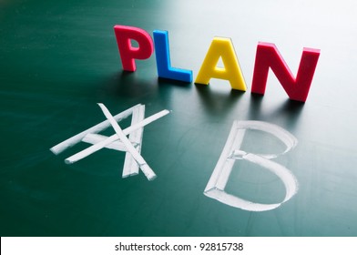 Crossing out Plan A and writing Plan B.