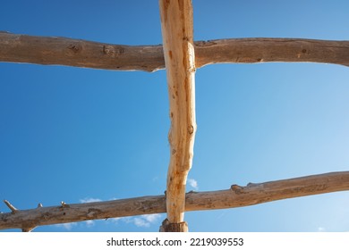 Crossing of wooden logs against the sky. Construction of a self-made tourist hut. - Shutterstock ID 2219039553