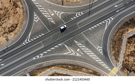 A Crossroads And A Passenger Car In The Middle Of The Desert Outside The City. High Quality Photo