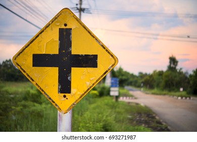 Crossroads Sign: A road sign warns of an intersection ahead.