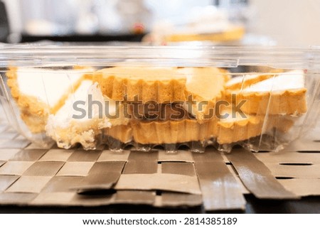 Cross-section of a cheese tart packed in a container