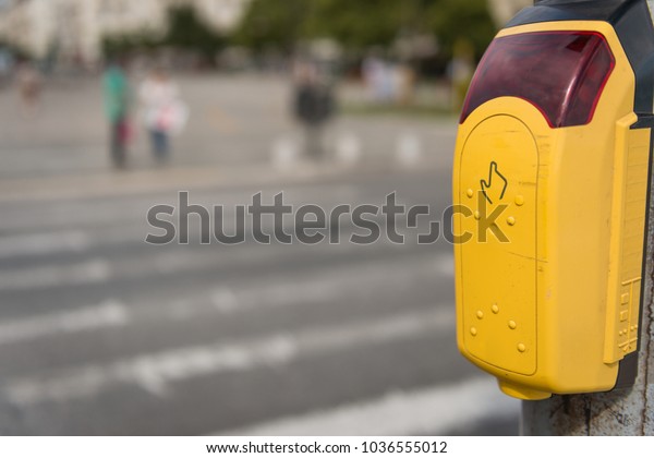 Crosswalk button\
for pedestrian with light\
warning