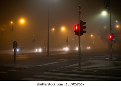 Crosswalk In The City With Pedestrian Red Stop Light At Night. Tick Fog, Bad Weather Conditions, Reduced Visibility. 